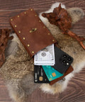Medieval Belt Pouch Set With Leather Bracers And Hook Strap For Cosplay And Festival Gear with phone and cards on fur