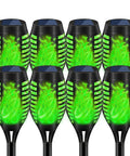 Solar Torch Lights For Garden Decor 8 Pack 12 LED Flickering Flame Outdoor Pathway Lights, close-up view of green glow.