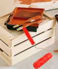 Professional Grade Slick Wood Grain Texture Paint Roller For Interior Wall Decoration on a wooden crate with paint tools.