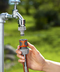 5/8 Inch Faucet End Hose Repair Quick Connector With Water Stop For Garden Hoses Between Tap And Hose Fittings 3/4 Inch Compatible Watertight Hose Repair Adapter Easy No Sweat Tap To Hose End Fix shown attached to a garden tap and hose.