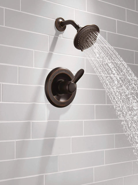 High End Lahara 14 Series Shower Trim Kit In Oil Rubbed Bronze, five spray settings, installed, water splashing.