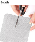 Window Screen Patch Kit With 10 4X4 Black Patches Self Adhesive 3 Layer Mesh Tape being cut with scissors