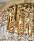 Close-up of Modern K9 Crystal Raindrop Chandelier Ceiling Light With Brass Canopy, 9 Light Flush Mount with warm gold finish