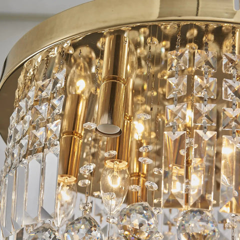Close-up of Modern K9 Crystal Raindrop Chandelier Ceiling Light With Brass Canopy, 9 Light Flush Mount with warm gold finish