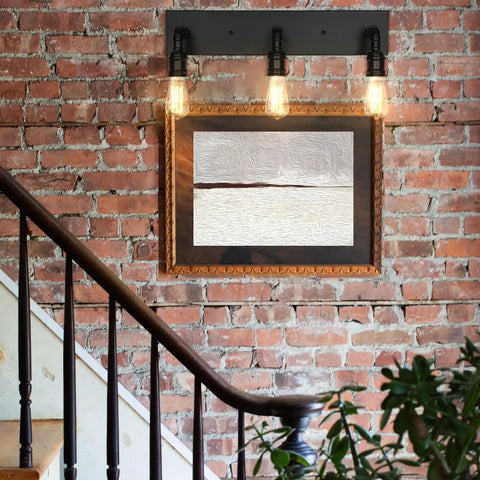 Industrial Farmhouse Vanity Light With Three Lights Water Pipe Wall Sconce For Powder Room Bedroom Dressing Room And Entryway Modern Bath Lighting Dope Industrial Vibe mounted on brick wall above staircase.