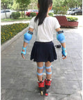 Child wearing red roller skates with Kids Knee Pads Elbow Pads And Wrist Guards Set for multi sport adventures outdoors.