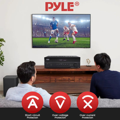 Two people watching soccer with 5.2 Channel Hi Fi Home Theater Receiver With 1000W Peak Power Wireless Bluetooth 4K Ultra HD Pass Through MP3 USB DAC Immersive Surround Sound Amplifier For Movie Nights And Party Vibes shown below TV.