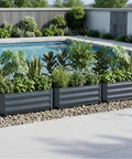 Three grey Two Pack Galvanized Raised Garden Beds With Bottom Indoor And Outdoor Use Rust Proof Metal Planter Box by a pool with plants.