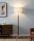 LED Floor Lamp With Walnut Wood Finish And Drum Shade Mid Century Modern Style For Living Room Office And Bedroom Decor Tall Standing Lamp For Modern Homes next to a sofa and credenza.