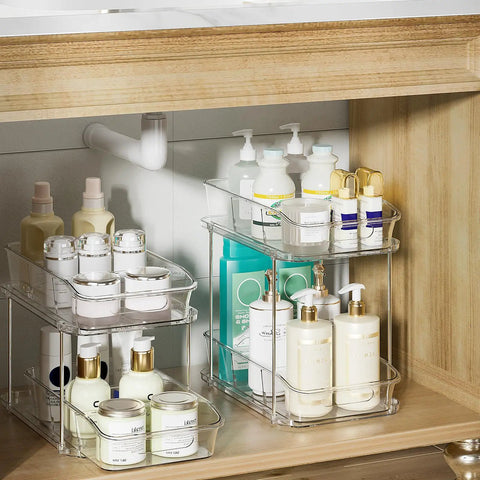 Slick Clear Under Sink Organizers And Storage Bins 2 Pack With High Low Design For Bathroom Cabinet Decluttering Pantry Organization showing stacked toiletries.