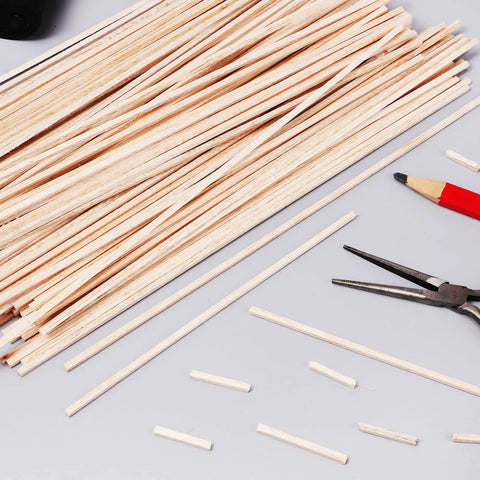 60 Pieces Unfinished Square Dowels One Eighth Inch Square Cross Section And Twelve Inches Long For DIY Molding Craft Projects Woodworking Perfect For DIYers And Makers, scattered on a table with tools.