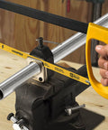 Hanpex 12in high-tension hacksaw frame with 24 TPI bi-metal blade, yellow handle, mounted in a bench vise.