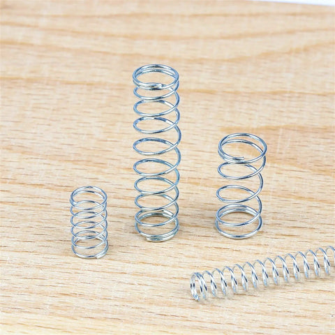 Must-Have Compression Spring Wire Kit with zinc plated steel extension springs on wooden surface, 200-piece set