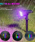 Solar Color Spotlight Lights Outdoor 35 LEDs Multicolor IP67 Waterproof 4 Pack illuminating grass with a purple glow.