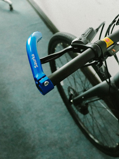 Close-up of blue bike handlebar with attached bar end, showing Aluminum MTB Bike Bar Ends For Mountain Bikes Handlebar Extenders.
