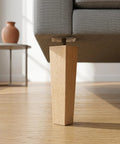 Close-up of Solid Wood Sofa Legs 6.7 Inches with Screws, showing sturdy wooden leg attached to couch base on wooden floor.