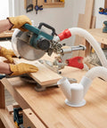 Heavy Duty Red Dust Hood For Machinery And Automatic Dust Collection Systems mounted on a miter saw capturing sawdust.