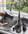 Kiamith 300W Cold Press Juicer With Huge 5.8 Inch Wide Feed Chute being cleaned at sink with water running.