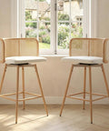 Set Of 4 Swivel Rattan Bar Stools, 26 Inch Counter Height With Natural Woven Back And White Faux Leather Seats in bright kitchen