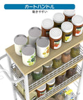 Top view of Slim 4 Tier Rolling Storage Cart with Wood Top holding jars, ideal for narrow spaces in kitchens and bathrooms
