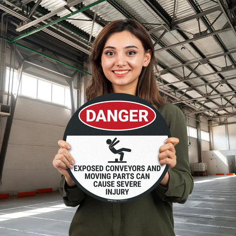 Warning Floor Decal For Machinery Areas Danger Exposed Conveyors And Moving Parts Can Cause Severe Injury held by woman