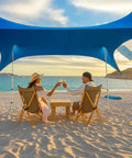 Easy Setup Beach Canopy Tent 8.5x9 Ft UPF50 Plus Sun Shade Portable Four Post Shelter over two people seated at the beach.