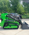Side view of a Compact Mini Skid Steer Loader with Bucket Attachment on parallel dual tracks, suitable for gardens, farms, and parks.