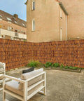 Natural Reed Fencing Roll 4 By 16 Ft Handwoven Bamboo Privacy Screen For Balcony Patio Garden Backyard Outdoor Use Light Russet Finish Decorative Reed Curtain For Privacy Shade And Easy Outdoor Vibe installed in an outdoor patio scene