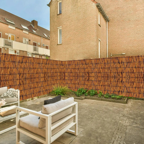 Natural Reed Fencing Roll 4 By 16 Ft Handwoven Bamboo Privacy Screen For Balcony Patio Garden Backyard Outdoor Use Light Russet Finish Decorative Reed Curtain For Privacy Shade And Easy Outdoor Vibe installed in an outdoor patio scene