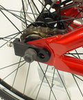 Close-up of rear wheel and chainstay on Salire SJ-50 Dirt Jumper Bike With Disc Brakes And 26 Inch Wheels, red steel frame detail.
