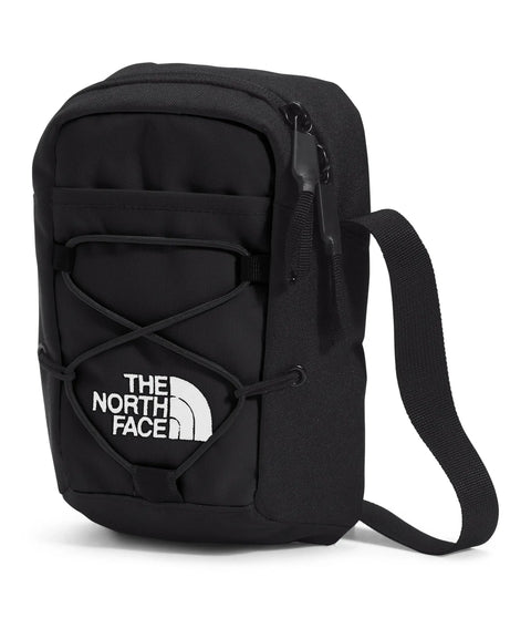 Jester Crossbody Bag featuring adjustable strap and bungee system in black, showcasing multiple carry options and water-repellent fabric.