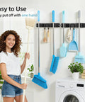 Stainless Steel Broom Holder Wall Mount 2 Pack Heavy Duty Mop Organizer With 2 Slots And 2 Hooks installed in laundry room