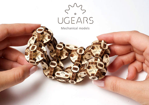 Flexi Cubus Mechanical Anti Stress Puzzle Twist Spin And Reconfigure Eight Jointed Spheres Into Dynamic Cube Forms For Stress Relief Spatial Awareness Practice Brain Teasing Fun Dope On The Go Chill wooden puzzle held in hands