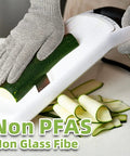 Person using Pro Grade ANSI Cut Resistant Food Grade Gloves For Kitchen Prep And Meat Cutting Oyster Shucking And Fish Fillet Mandoline Safety Gear With Ultra Strong Fibers And Stainless Steel For Heavy Duty Home Or Pro Use while slicing zucchini on a mandoline.