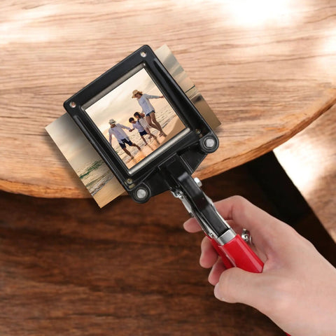 Go-To 50X50Mm Square Photo Cutter Handheld Die Punch Tool being used on a photo for crafting projects, ergonomic red handle