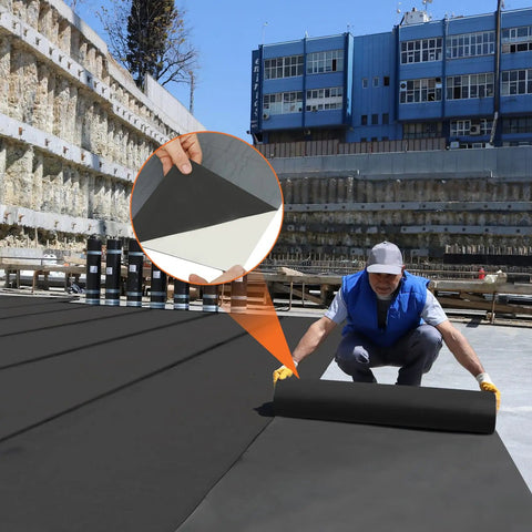 Worker installing Built Tough 51 Mil Epdm Rubber Roofing Rolls With Peel And Stick Backing on a flat surface.
