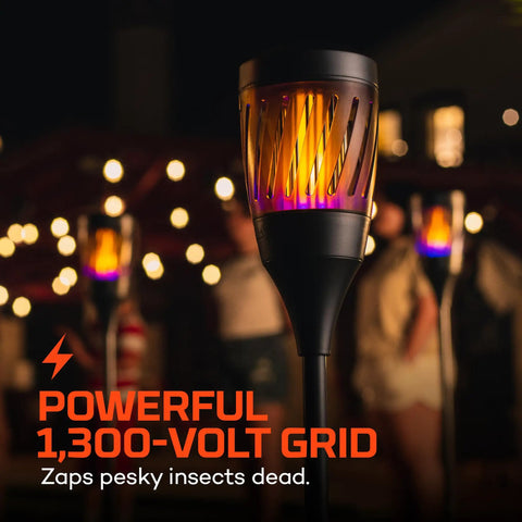 Outdoor Solar Torch Zapper Bug Light With Warm Tiki Torch Ambience Solar Powered And Rechargeable Battery Keeps Mosquitoes Flies And Gnats Away Three Light Modes For All Night Yard Vibes, glowing in a dark outdoor setting.