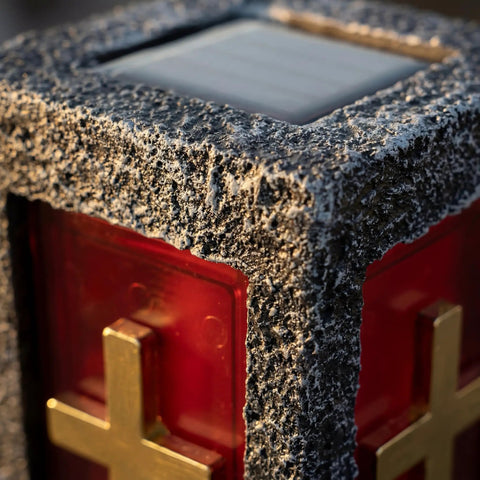Close-up of Blue Cemetery Light with textured surface and gold cross detail on anodized aluminum, for grave markers and memorials