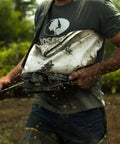 Man using Handheld Seed Spreader For Quick Lawn Sowing With Calibrated Flow Control, 25 lb capacity, in garden