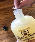 Deep Penetrating Food Grade Butcher Block Conditioner bottle with lid being opened, ideal for hardwood and bamboo surfaces, 1 gallon.