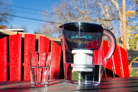 Clear water pitcher with Pure Replacement Filter For Water Pitcher That Removes Fluoride Lead Forever Chemicals Heavy Metals outdoors.