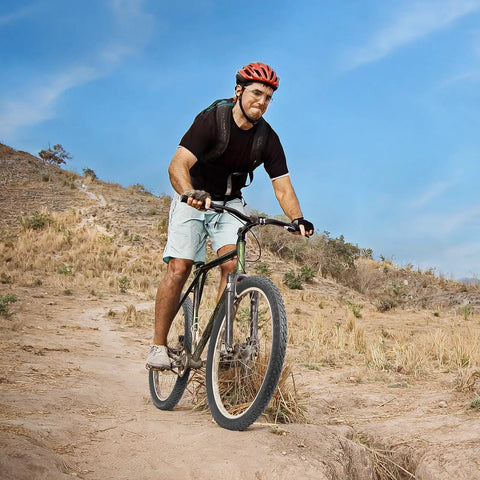 Cyclist riding with 2 Pack 24 Inch Mountain Bike Tires And Tubes Set 24x1.75/47-507 Heavy Duty Tubes on rugged trail