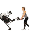 Woman adjusting the Smooth Riding Indoor Cycling Bike Featuring Forty Pound Rear Flywheel And Digital Console.