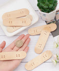 Hand holding 8 Pack Mini Fingerboard Set Maple Wood With Plastic Case Tiny Skateboards, showing size comparison with a coin.