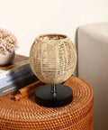 Three Pack Rattan Lamp Shades Vintage Boho Hanging Light Covers displayed on a wicker table next to a pink flower pot and books