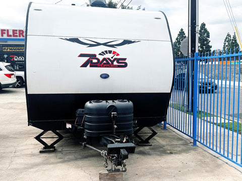 Dual 30Lb LP Propane Tank Cover For RVs And Travel Trailers Heavy Duty Black Plastic With Side Regulator Access Port And Individual Top Hatches Fits Two Tanks Easy Access For Camper And Recreational Vehicle installed on trailer.