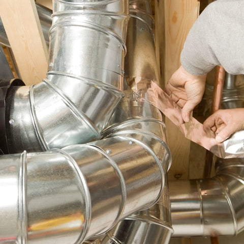 Applying Heavy Duty Aluminum Foil Tape 4 Inch Wide By 55 Yards Pro Grade Extra Wide Silver Metal Tape for HVAC sealing on ductwork.