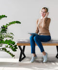 Woman sitting on bench with Beefy 16 Inch Heavy-Duty Metal Table Legs Set Of 2 Black With Double Triangle Z Shape Design, Supports Up To 1000 Lbs.