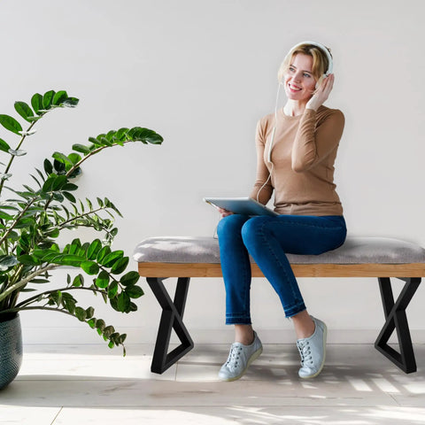 Woman sitting on bench with Beefy 16 Inch Heavy-Duty Metal Table Legs Set Of 2 Black With Double Triangle Z Shape Design, Supports Up To 1000 Lbs.