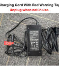 Charging cord for Beast 1500W Peak And 1000W Continuous Motor Electric Bike with red warning tag, unplug when not in use